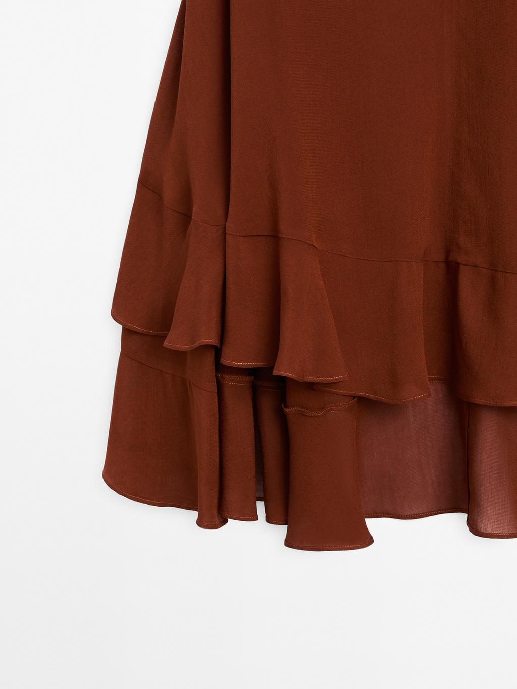 Cape-style blouse with ruffles