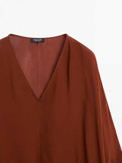 Cape-style blouse with ruffles