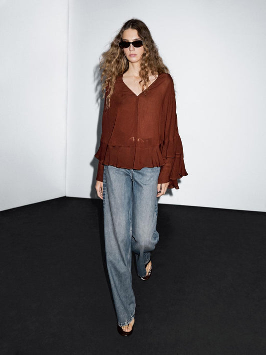 Cape-style blouse with ruffles